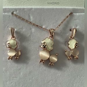 Necklace and earrings. Gold rose French poodle figure. CAMILLA Madrid brand.